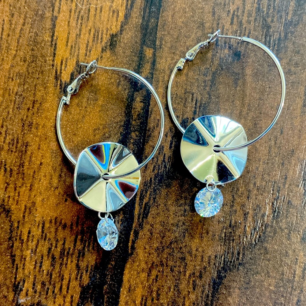 Shiny hoops with dangling crystals